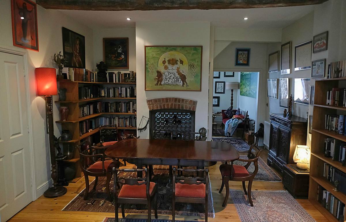 The dining room, with bookshelves and a framed painting