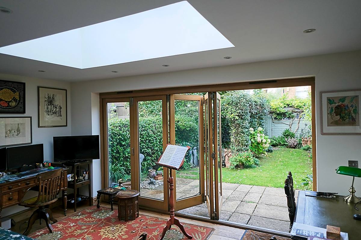 A room with glass doors opening onto the garden